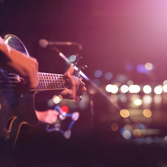 Guitarist on stage for background, soft and blur concept